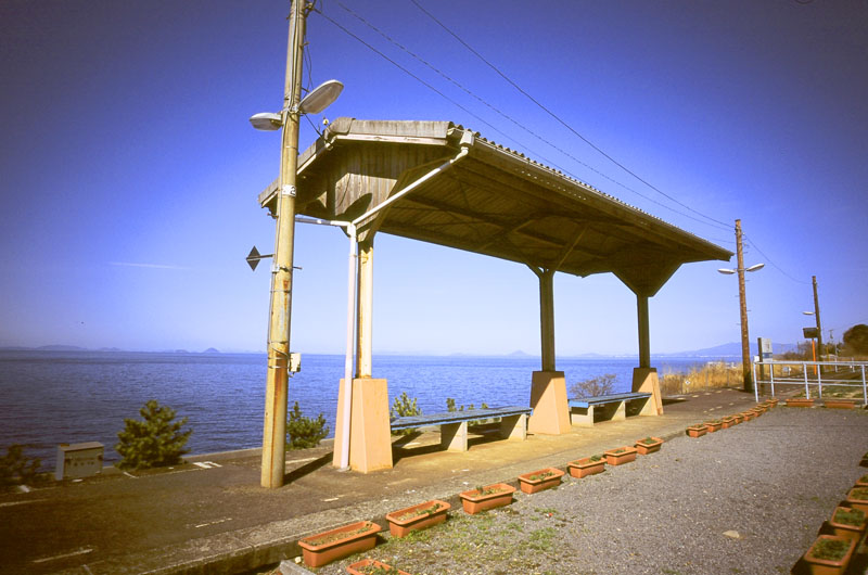 Image shows a rural train platform by the coast