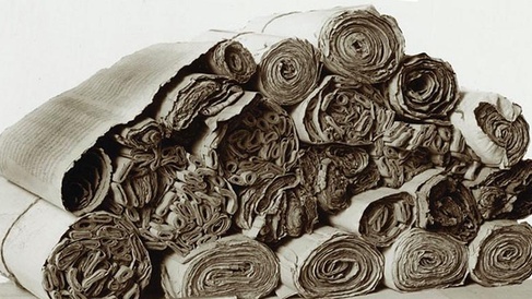 A selection of the Dunhuang manuscripts individually rolled up and collectively piled together.