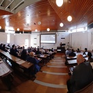 People listening to a lecture and watching a screen in a lecture hall