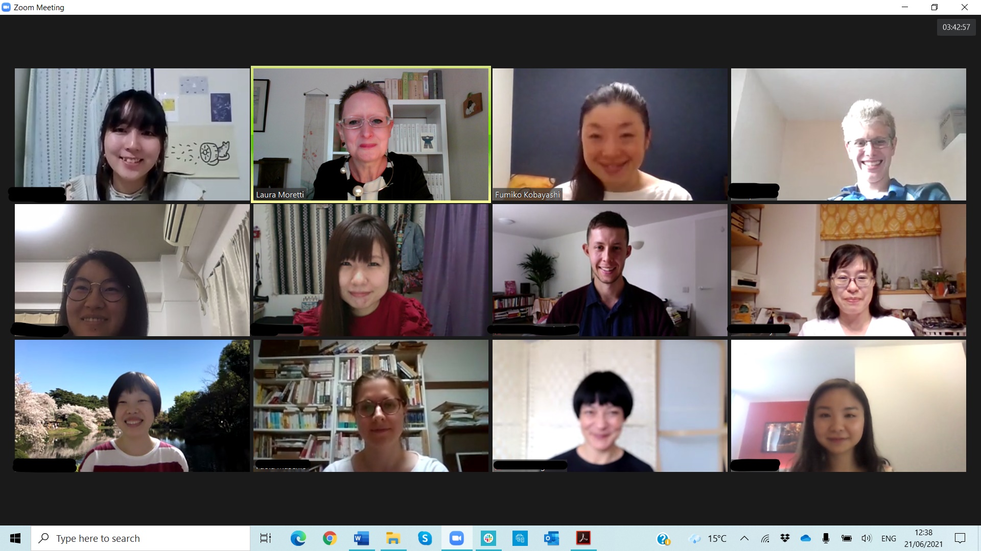 Image shows screenshot of Zoom meeting with 3 rows of participants, smiling